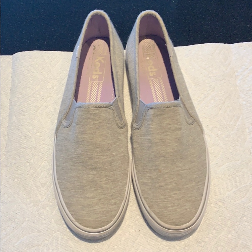 Light grey sneakers.